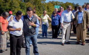 Greenville mayor Allen Thomas (black vest) and others gathered to pray